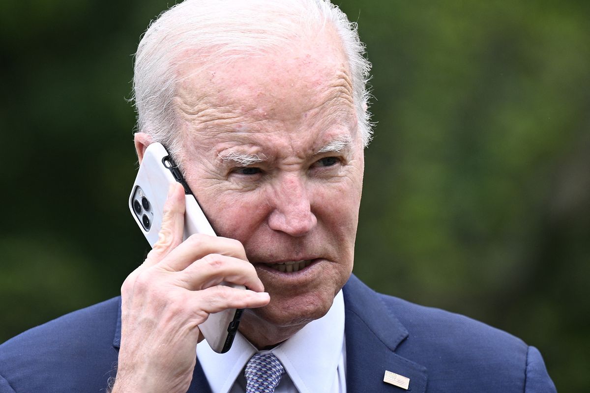 US President Joe Biden speaks on the phone during a National Small Business Week event in the Rose Garden of the White House in Washington, DC, on May 1, 2023. (Photo by Brendan SMIALOWSKI / AFP)