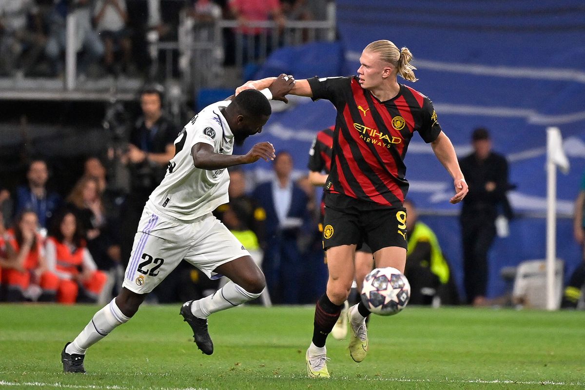 Manchester City's Norwegian striker Erling Haaland (R) vies with Real Madrid's German defender Antonio Rudiger during the UEFA Champions League semi-final first leg football match between Real Madrid CF and Manchester City at the Santiago Bernabeu stadium in Madrid on May 9, 2023. (Photo by OSCAR DEL POZO / AFP)