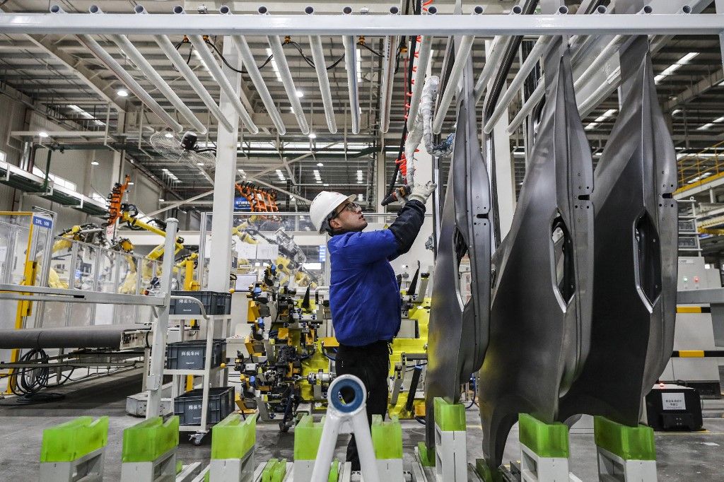 This photo taken on February 21, 2024 shows an employee working on a new energy vehicle assembly line at a BYD factory in Huai'an, in China's eastern Jiangsu province. (Photo by AFP) / China OUT