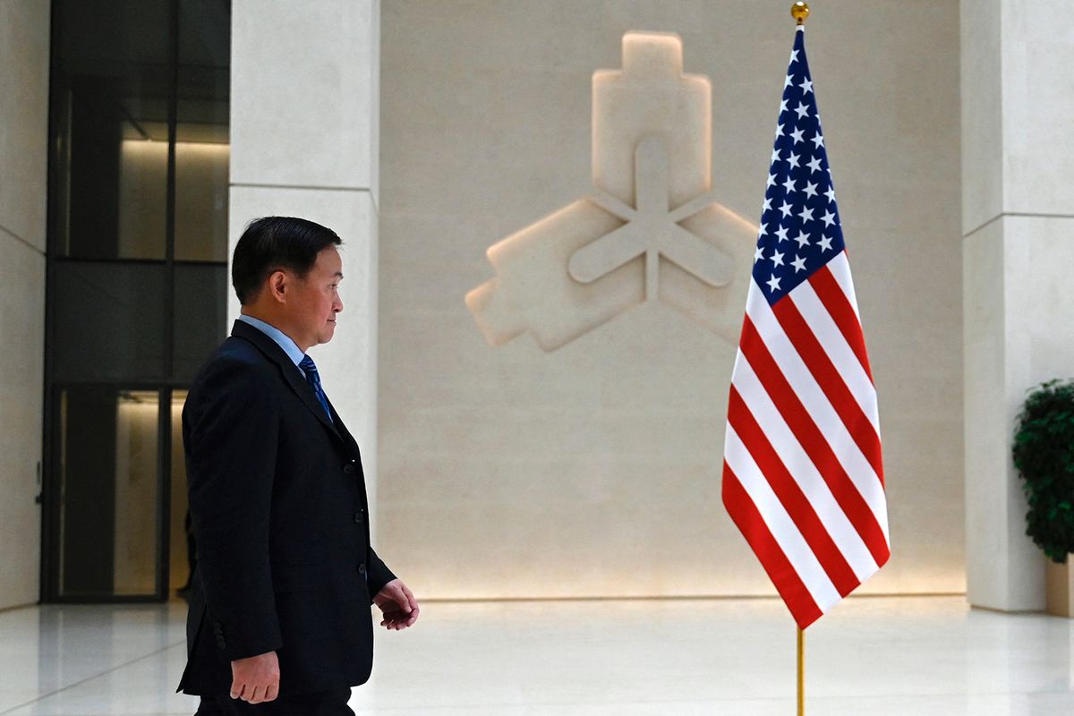People's Bank of China Governor Pan Gongsheng is seen beside a US flag as he waits for the arrival of US Treasury Secretary Janet Yellen to the central bank's headquarters in Beijing on April 8, 2024. (Photo by Pedro Pardo / AFP)