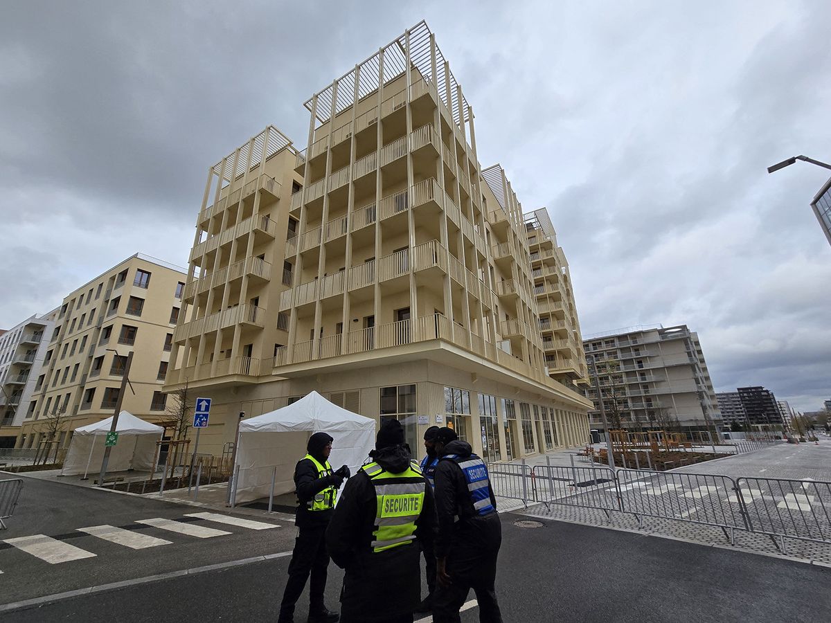 SAINT-OUEN, FRANCE - MARCH 31: Security guards stand in front of residential accommodation buildings at the Olympic village where the athletes will be housed during the Paris 2024 Olympic Summer Games in Saint-Ouen, near Paris, France on March 31, 2024. Mustafa Yalcin / Anadolu (Photo by MUSTAFA YALCIN / ANADOLU / Anadolu via AFP)
