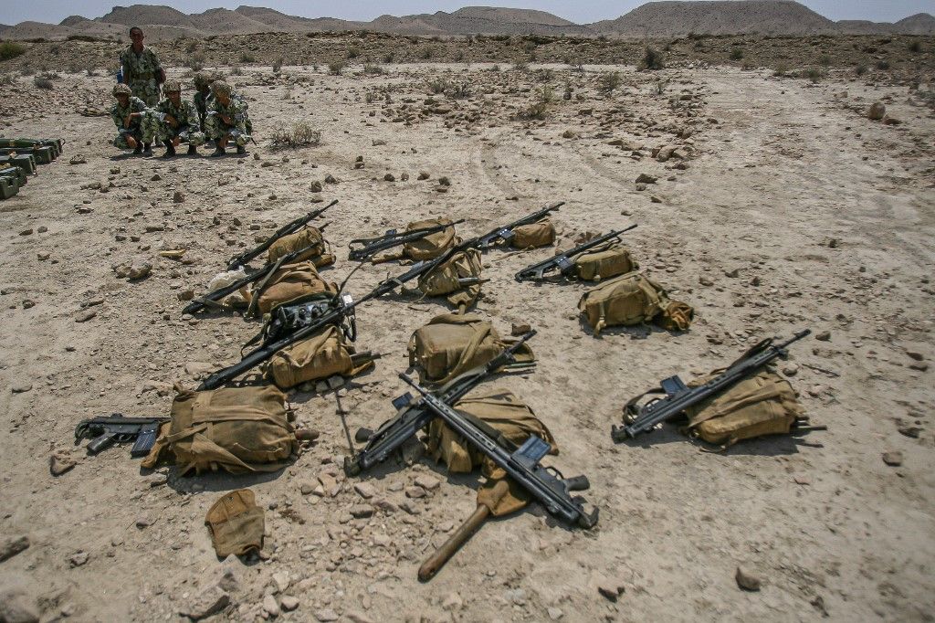 Iranian Army Military DrillSoldiers from the Islamic Republic of Iran Army coruch next to their weapons during a during a military drill dubbed “Zolfaghar” in Hormozgan province in south Iran on Sunday, August 27, 2006. (Photo by Hossein Fatemi / Middle East Images / Middle East Images via AFP)