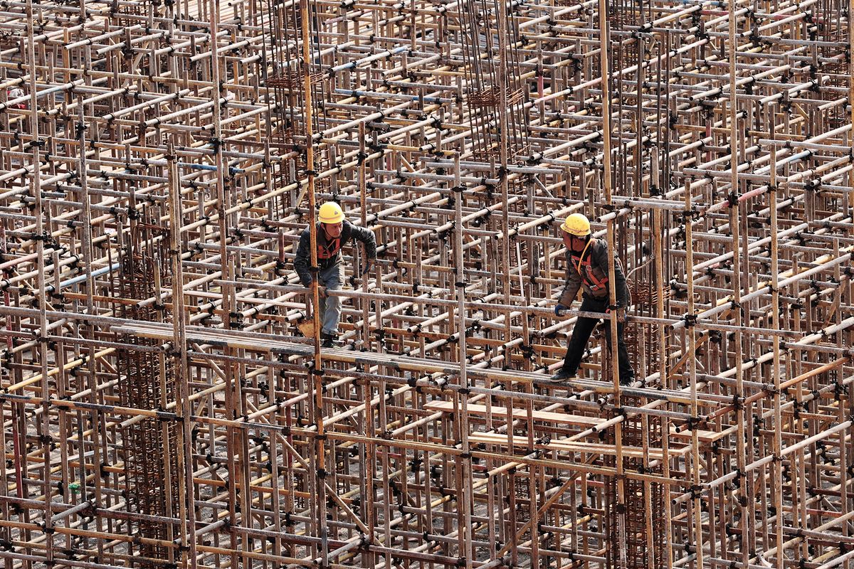 Workers are working on the construction site of the comprehensive transportation hub of Qianjiang Station of the Chongqing-Changsha High-speed Railway in Chongqing, China, on February 18, 2024. (Photo by Costfoto/NurPhoto) (Photo by CFOTO / NurPhoto / NurPhoto via AFP)