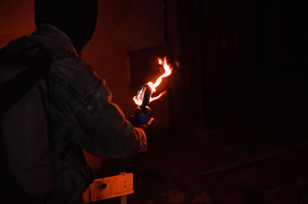 Protester,Burn,Molotov's,Cocktail,Preparing,To,Throw, Molotov-koktél