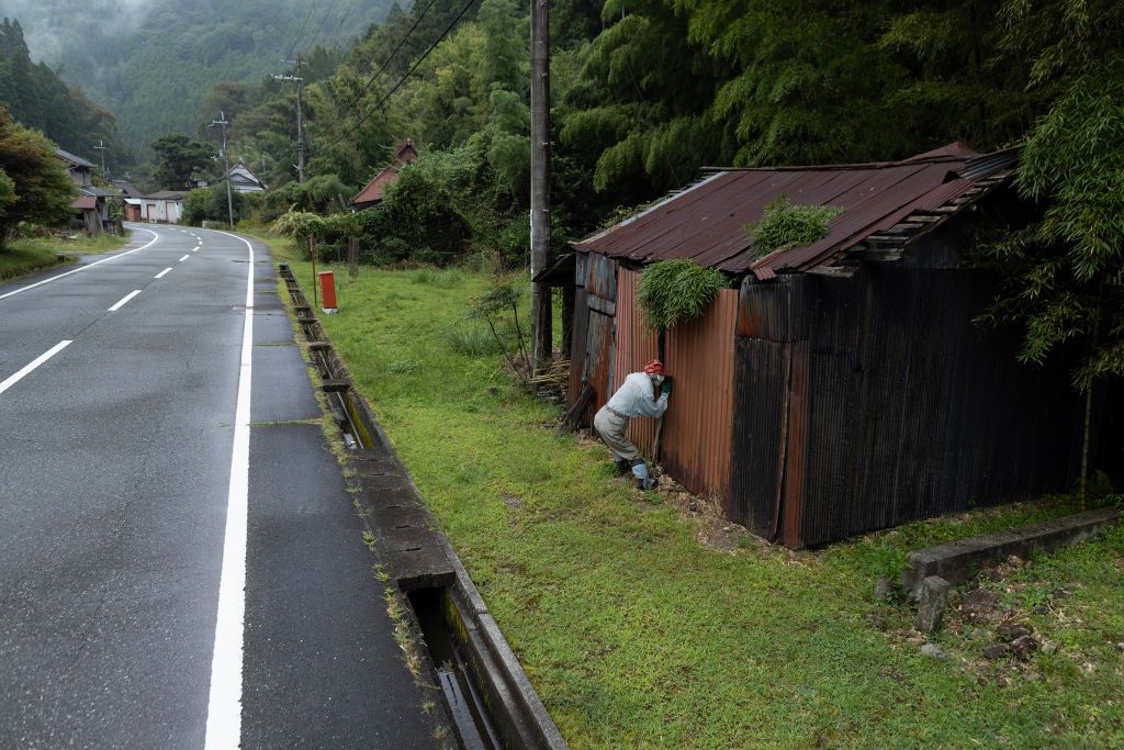 YASUTOMI, JAPAN - SEPTEMBER 20: A handmade human-sized scarecrow is positioned outside the abandoned farmhouse as if looking into the building in the village of ‘Kakasi No Sato’ on September 20, 2023 in Yasutomi, Japan. Masato Okaue, 71, has created human-sized scarecrows and placed them around his village to remind people that there are still 10 villagers who are 65 or older, who are still living there. Since 2010, he has set more than 130 scarecrows around farmlands, roadsides and abandoned houses to illustrate the old Japanese countryside and show that villages are not completely deserted. Due to dwindling birth rates and migration to urban areas, 8 houses are occupied among the 30 houses in the village and others are abandoned, which is emblematic of a similar phenomenon taking place across Japan. Japan's elderly population aged 65 and older reached a record high of 29.1%, according to the Internal Affairs and Communications Ministry statistics issued last Monday. (Photo by Buddhika Weerasinghe/Getty Images)