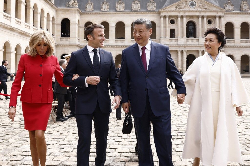 From left: Brigitte Macron and her husband French President Emmanuel Macron, Chinese President Xi Jinping and his wife Peng Liyuan, walk together at the end of the official welcoming ceremony, as part of the Chinese President's two-day state visit, at The Invalides in Paris on May 6, 2024. Xi's two-day state visit to France is his first visit to Europe since 2019 on a trip that will also see him hold talks in Serbia and Hungary. He has said he wants to find peace in Ukraine even if analysts do not expect any major breakthrough. (Photo by Yoan VALAT / POOL / AFP)