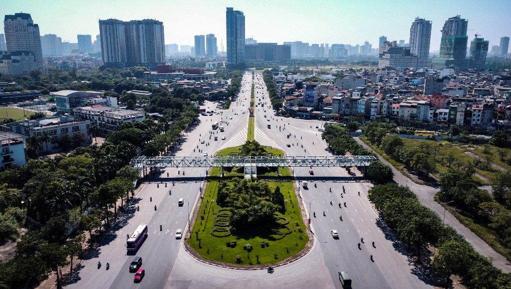 This aerial photo taken on October 11, 2022 shows motorists commuting on the Formula One track in Hanoi. Hanoi's Formula One race circuit lies largely abandoned as hopes fade that Vietnam's capital will ever host a Grand Prix. The city was due to make its F1 debut in 2020 but the event was shelved due to the Covid-19 pandemic and Hanoi has not appeared on the race calendar since. (Photo by Nhac NGUYEN / AFP)