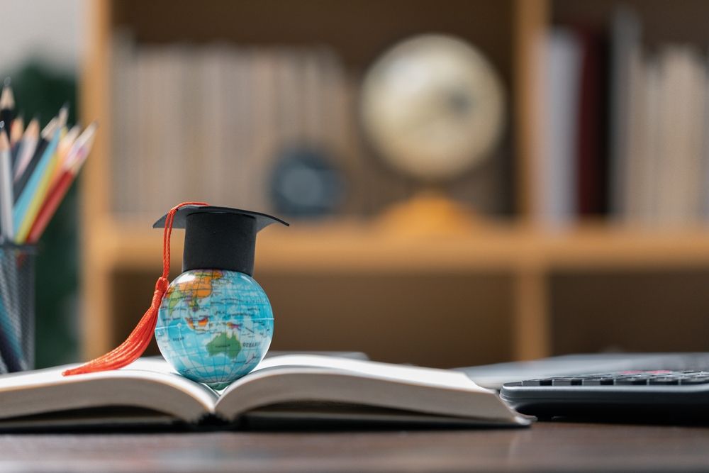 Graduation,Cap,With,Earth,Globe.,Concept,Of,Global,Business,Study,