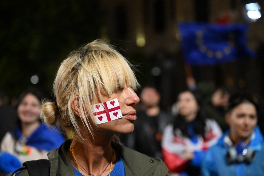 Demonstrators protest the controversial "foreign influence" bill near the parliament in Tbilisi on May 13, 2024. Several thousand Georgians gathered outside parliament in Tbilisi on May 12,  in a fresh protest against a Russian-styled "foreign agent" bill, despite government officials warning of arrests. (Photo by Vano SHLAMOV / AFP)