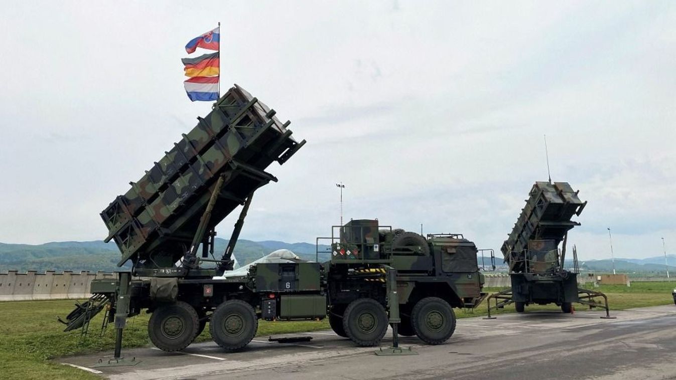 06 May 2022, Slovakia, Sliac: The launchers of a German (front) and a Dutch Patriot air defense system stand at the city's airport. Above them fly the flags of the three deploying nations, Slovakia, Germany and the Netherlands. Defense Minister Lambrecht is there visiting the German soldiers who were deployed there as part of the NATO response to the war in Ukraine. Photo: Carsten Hoffmann/dpa (Photo by CARSTEN HOFFMANN / DPA / dpa Picture-Alliance via AFP) NATO