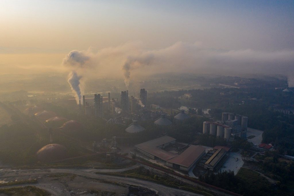 Smoke is discharged from chimneys at a cement plant in Qingyuan city, south China's Guangdong province, 12 March 2019. (Photo by Liang jie / Imaginechina / Imaginechina via AFP)