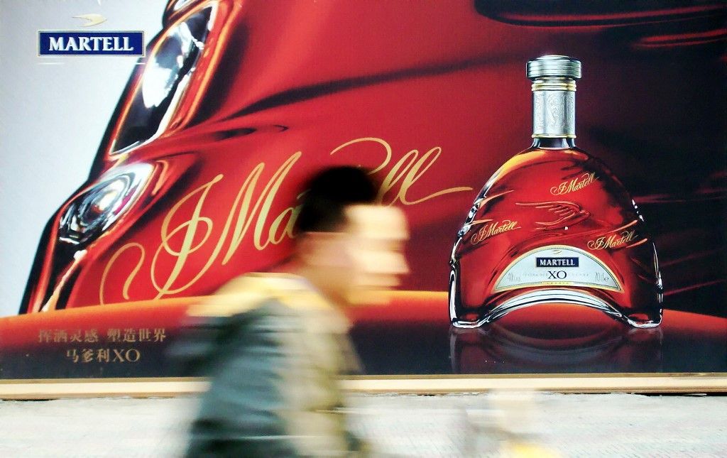 Pernod Plans to expand in China despite government crackdown--FILE--A man cycles past an advertisement for Martell XO cognac in Shanghai, China, 12 April 2010.

Pernod Ricard SA executives have a plan to battle a slowing Chinese economy in which high-end spirits are taking a beating: expand anyway. The French maker of whiskey brands such as Chivas and cognacs including Martell is opening members-only clubs in China, cozying up to wealthy individuals and hosting gatherings of 10 or fewer VIP customers to win more drinkers of Champagne, cognac, wine, whiskey and vodka, executives said in Beijing. (Photo by Jing wei / Imaginechina / Imaginechina via AFP)
