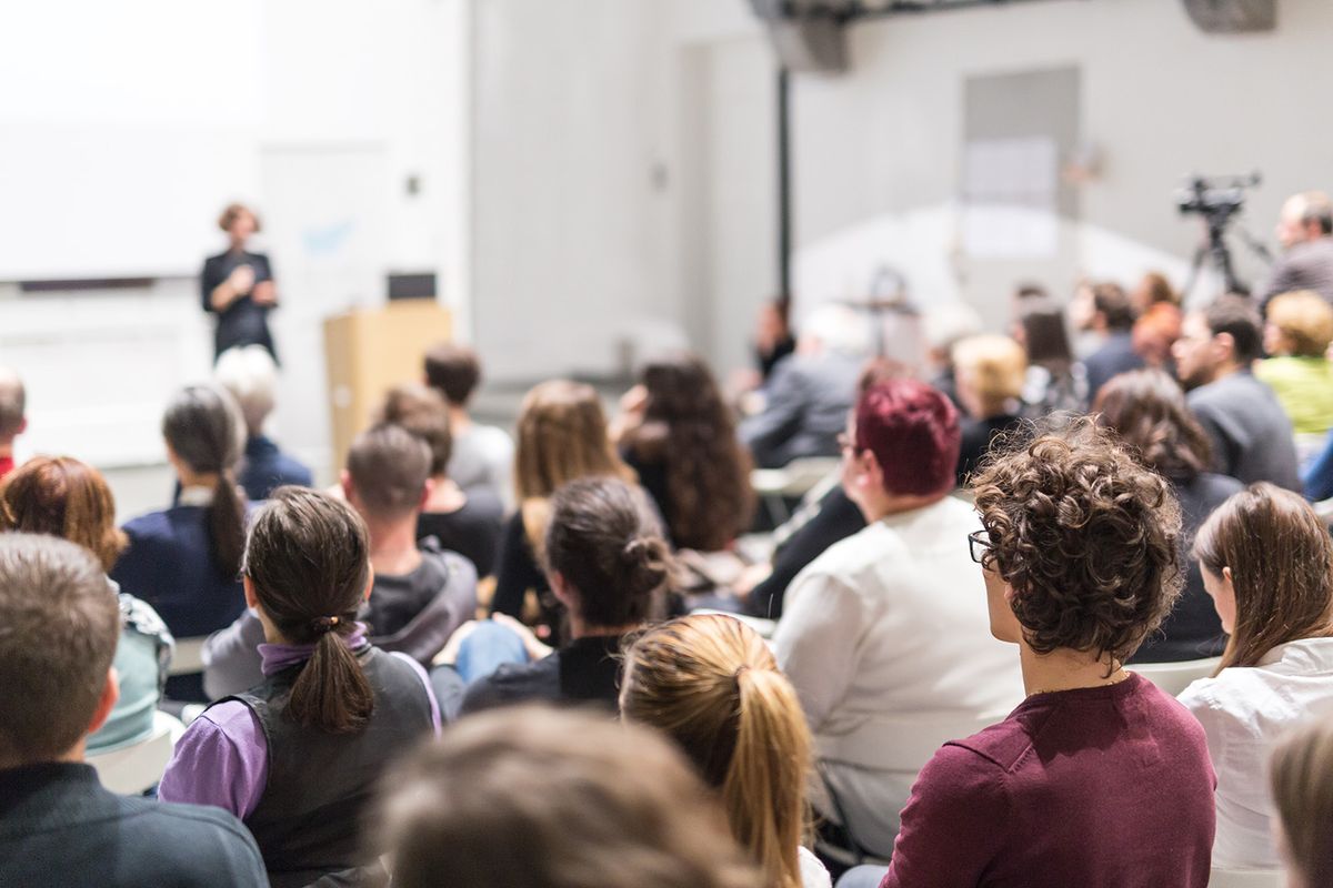 Female,Speaker,Giving,Presentation,In,Lecture,Hall,At,University,Workshop.