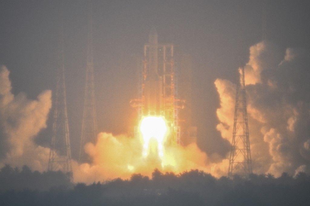A Long March 5 rocket, carrying the Chang'e-6 mission lunar probe, lifts off as it rains at the Wenchang Space Launch Centre in southern China's Hainan Province on May 3, 2024. (Photo by Hector RETAMAL / AFP)