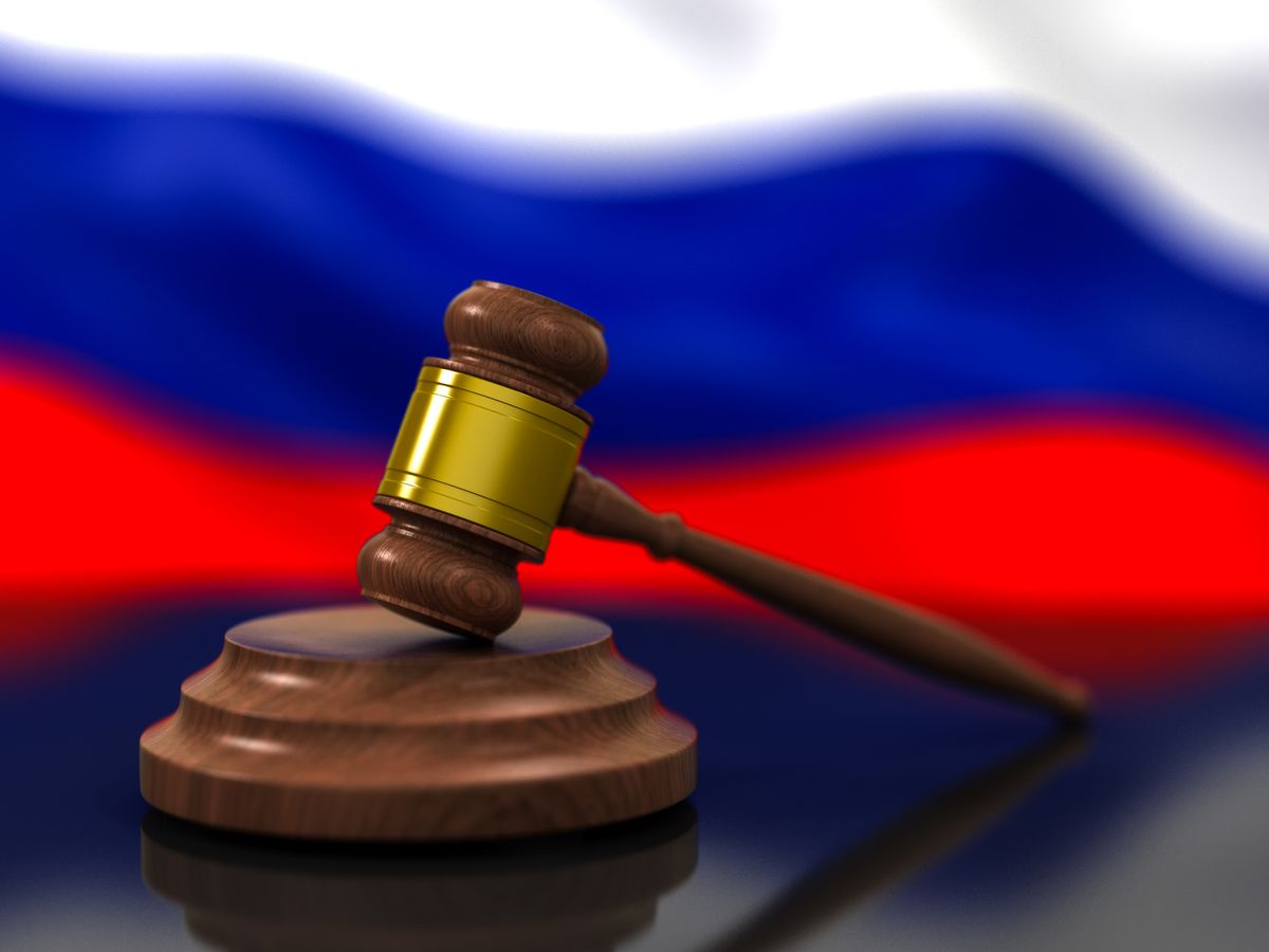 Wooden Judge Gavel and Flag of Russia