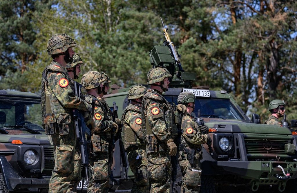 30 April 2024, Saxony, Weißkeißel: Bundeswehr soldiers stand in front of a Greenliner vehicle (l) and an Enok from the "Wolf class" during the "National Guardian 2024" exercise as part of the "Quadriga" series of Bundeswehr exercises at the Oberlausitz military training area. During the Bundeswehr exercise "National Guardian", homeland security forces throughout Germany are practising their core mission of protecting and securing vital defense infrastructure. Reserve service members of the Homeland Security Company from Saxony, Saxony-Anhalt and Thuringia are taking part in today's exercise. Photo: Robert Michael/dpa (Photo by ROBERT MICHAEL / DPA / dpa Picture-Alliance via AFP)