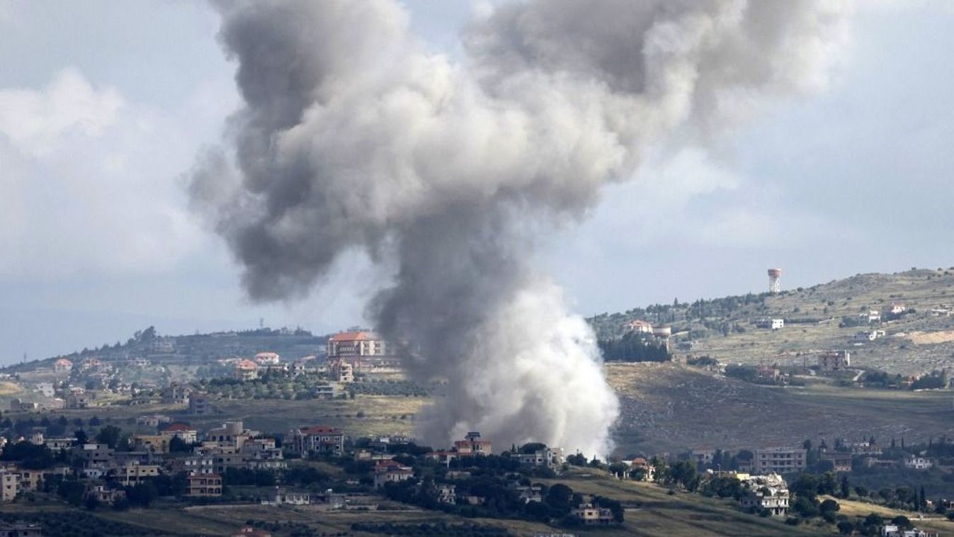 This picture taken from the northern Israeli kibbutz of Malkia along the border with southern Lebanon, shows smoke billowing above the Lebanese village of Mays al-Jabal  during Israeli bombardment on May 5, 2024, amid ongoing cross-border tensions as fighting continues between Israel and Palestinian Hamas militants in the Gaza Strip. A local official in southern Lebanon said an Israeli strike on Mays al-Jabal killed a couple and their child, the latest deadly incident in the border region. (Photo by Jalaa MAREY / AFP) izrael