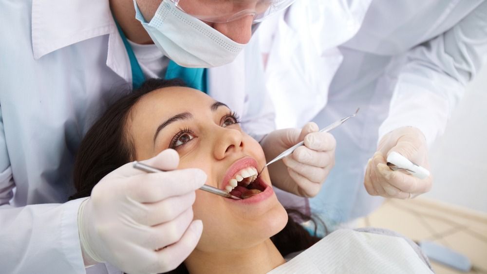 Dentist,And,His,Assistant,Carrying,Out,A,Thorough,Examination