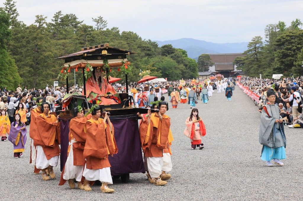 A parade of people wearing splendid ancient costumes and traditional leaves the Kyoto Imperial Palace during the Aoi Matsu Festival in Kyoto on May 15, 2024. ( The Yomiuri Shimbun ) (Photo by Kota Kawasaki / Yomiuri / The Yomiuri Shimbun via AFP)