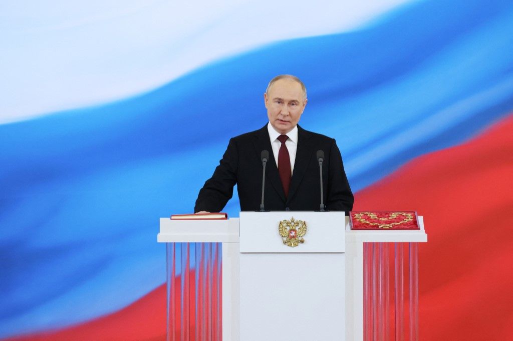 In this pool photograph distributed by Russian state agency Sputnik, Russian president-elect Vladimir Putin takes the oath of office during a ceremony at the Kremlin in Moscow on May 7, 2024. (Photo by Alexander KAZAKOV / POOL / AFP)