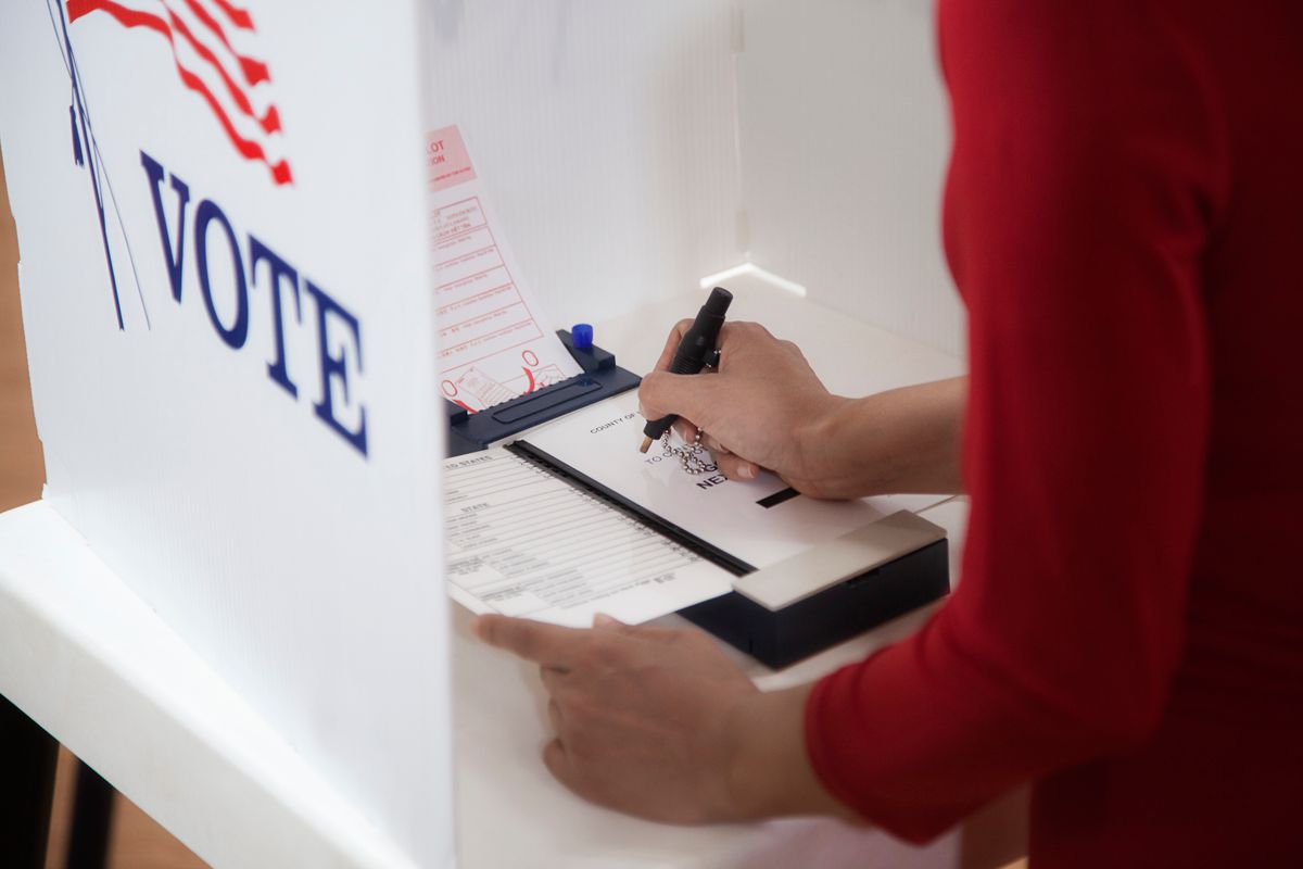 Asian voter voting in polling place