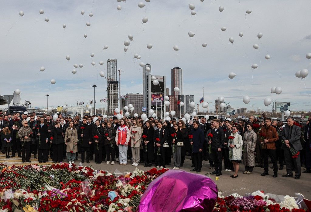 Ambassadors and representatives of diplomatic missions accredited in Russia release white balloons as they attend a flower laying ceremony at the memorial in memory of the victims of the terrorist attack at the Crocus City Hall concert venue a week after the attack in Krasnogorsk, outside Moscow on March 30, 2024. At least 144 people were killed and more than 100 hospitalized after a group of gunmen attacked the concert hall in the Moscow region on 22 March evening, Russian officials said. Eleven suspects, including all four gunmen directly involved in the terrorist attack, have been detained, according to Russian authorities. (Photo by SERGEI ILNITSKY / POOL / AFP)
