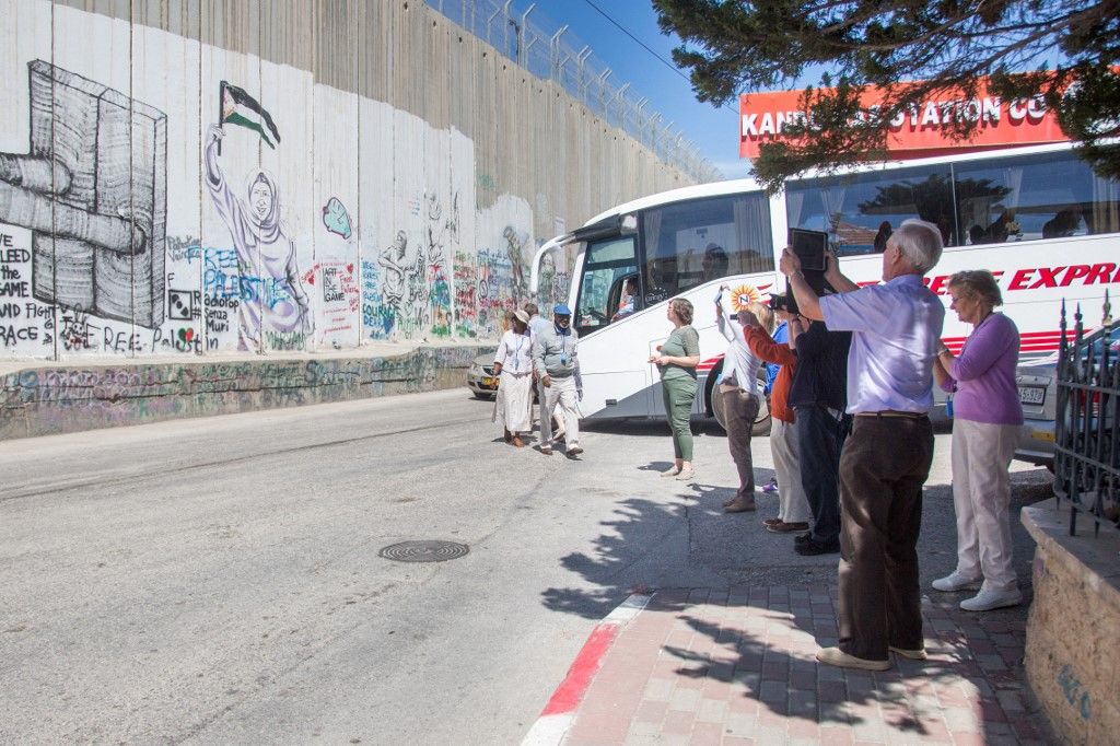 Foreign tourists in front of separation wall in Bethlehem, in West Bank, in March 2018.