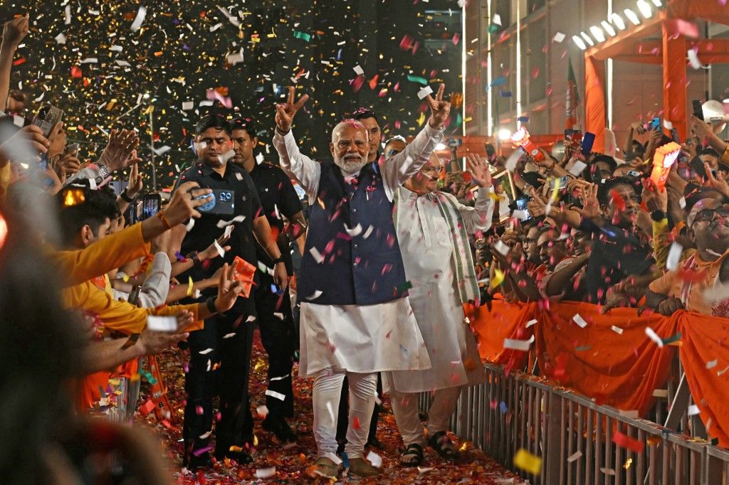 India’s Prime Minister Narendra Modi (C) flashes victory sign as he arrives at the Bharatiya Janata Party (BJP) headquarters to celebrate the party’s win in country's general election, in New Delhi on June 4, 2024. Modi claimed election victory for his party and its allies on June 4, but the opposition said they had "punished" the ruling party to confound predictions and reduce their parliamentary majority. (Photo by Arun SANKAR / AFP)