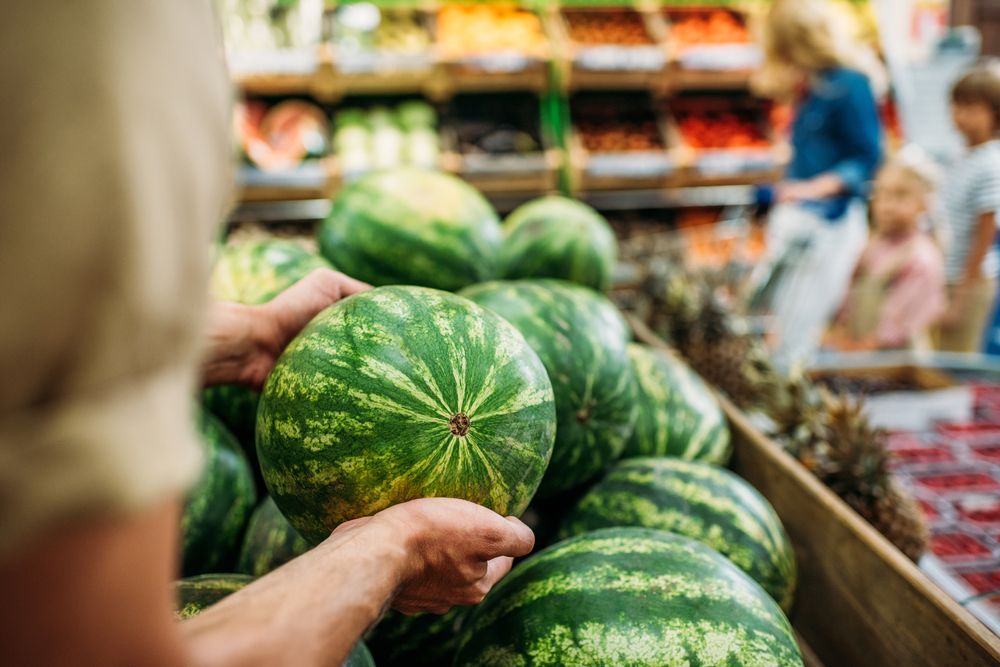 Partial,View,Of,Woman, dinnyeszezon, Picking,Watermelon,In,Grocery,Shop, dinnye