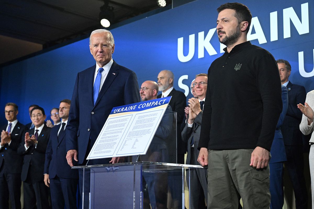 Ukrainian President Volodymyr Zelensky (R) and US President Joe Biden stand on stage during a meeting of the Ukraine Compact on the sidelins of the NATO 75th anniversary summit at the Walter E. Washington Convention Center in Washington, DC, on July 11, 2024. (Photo by SAUL LOEB / AFP)