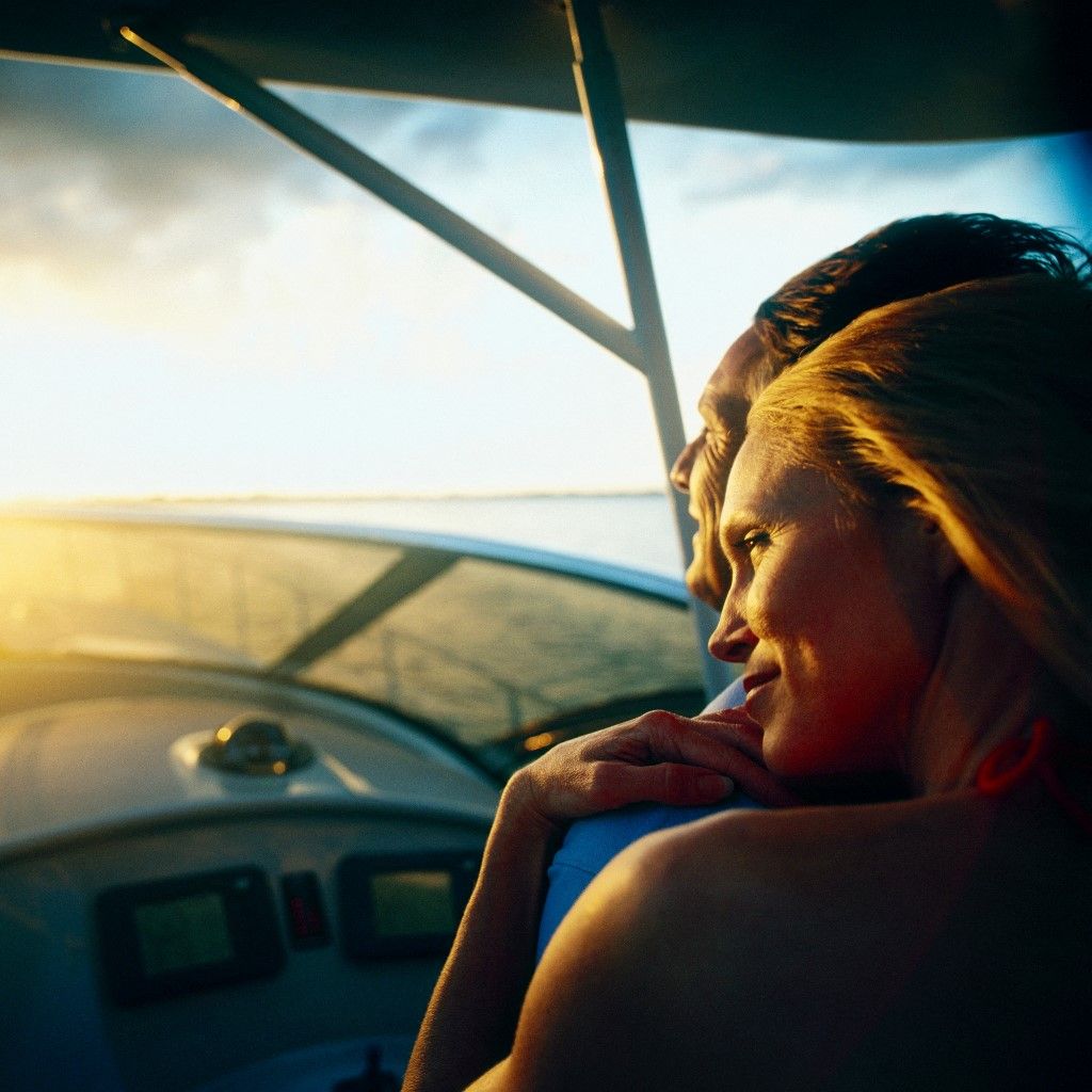 Woman relaxing on man's shoulder on boat at low light (Photo by Gary John Norman / Image Source / Image Source via AFP)