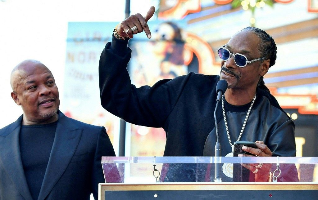 US rapper Dr. Dre (L) listens to US rapper Snoop Dog speak at his Hollywood Walk of Fame ceremony in Hollywood, California, on March 19, 2024. (Photo by VALERIE MACON / AFP)
Snoop Dogg