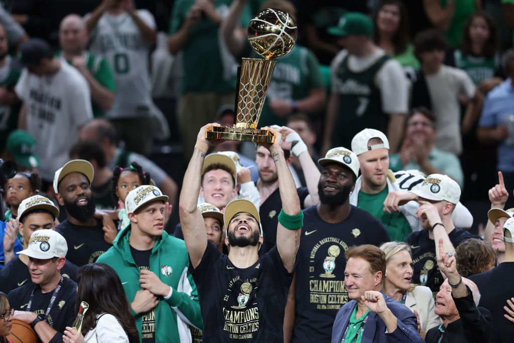 BOSTON, MASSACHUSETTS - JUNE 17: Jayson Tatum #0 of the Boston Celtics lifts the Larry O’Brien Championship Trophy after Boston's 106-88 win against the Dallas Mavericks in Game Five of the 2024 NBA Finals at TD Garden on June 17, 2024 in Boston, Massachusetts. NOTE TO USER: User expressly acknowledges and agrees that, by downloading and or using this photograph, User is consenting to the terms and conditions of the Getty Images License Agreement. (Photo by Adam Glanzman/Getty Images)