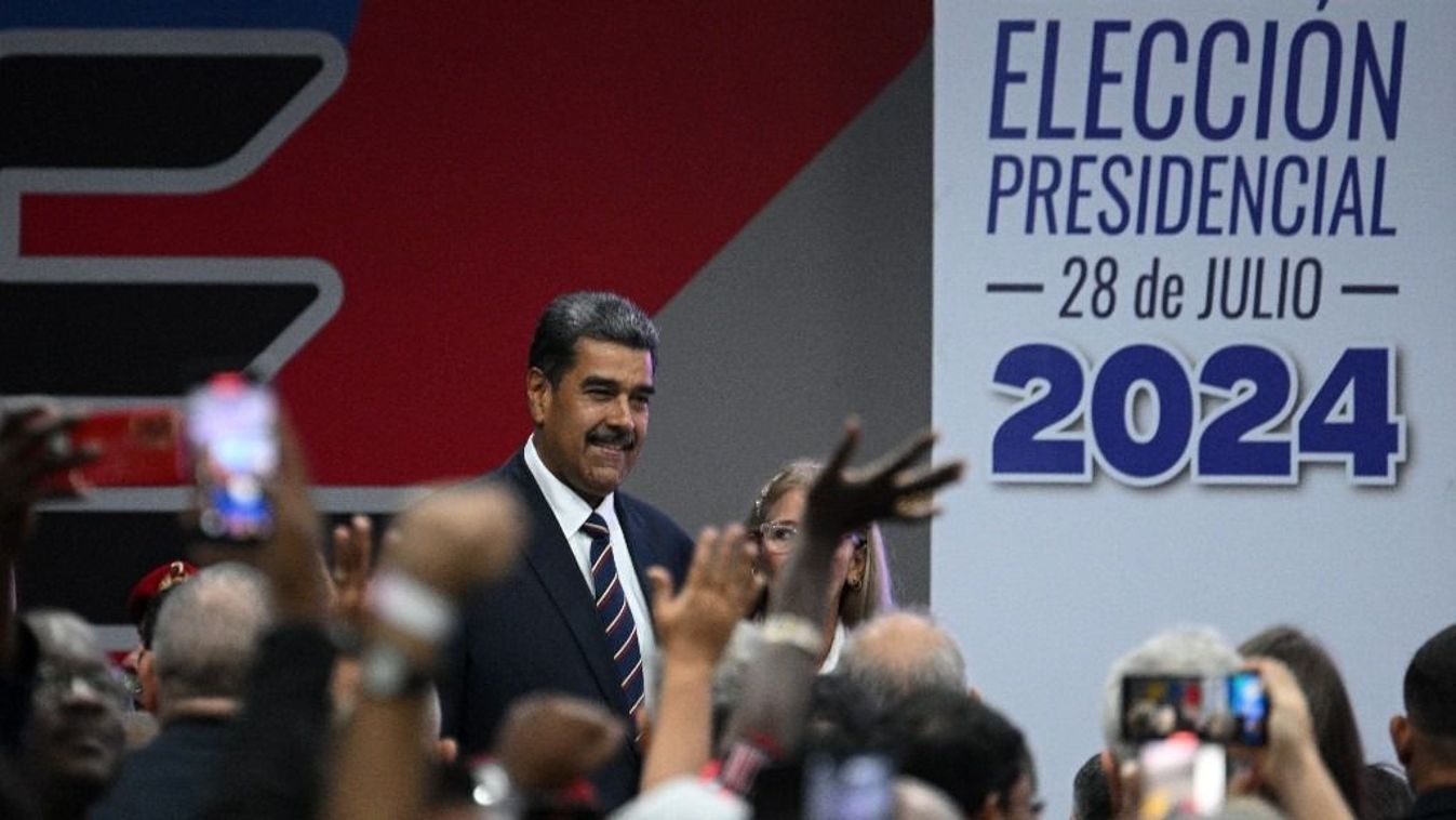 Venezuelan President Nicolas Maduro (L), accompanied by his wife Cilia Flores, attends his proclamation at the National Electoral Council (CNE) headquarters in Caracas on July 29, 2024, a day after the Venezuelan presidential election. President Nicolas Maduro was declared the winner of Venezuela's presidential election but the opposition and key regional neighbours immediately rejected the official results. (Photo by Federico PARRA / AFP)