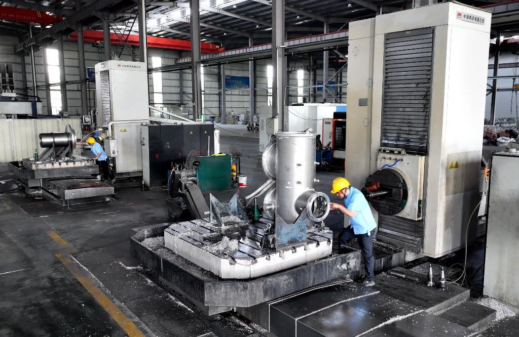 A worker is producing aluminum and steel housings for GIS high-voltage switches for the State grid at the Tongwei Group's production workshop in the high-tech zone in Hai'an, China, on July 16, 2024. (Photo by Costfoto/NurPhoto) (Photo by CFOTO / NurPhoto / NurPhoto via AFP)