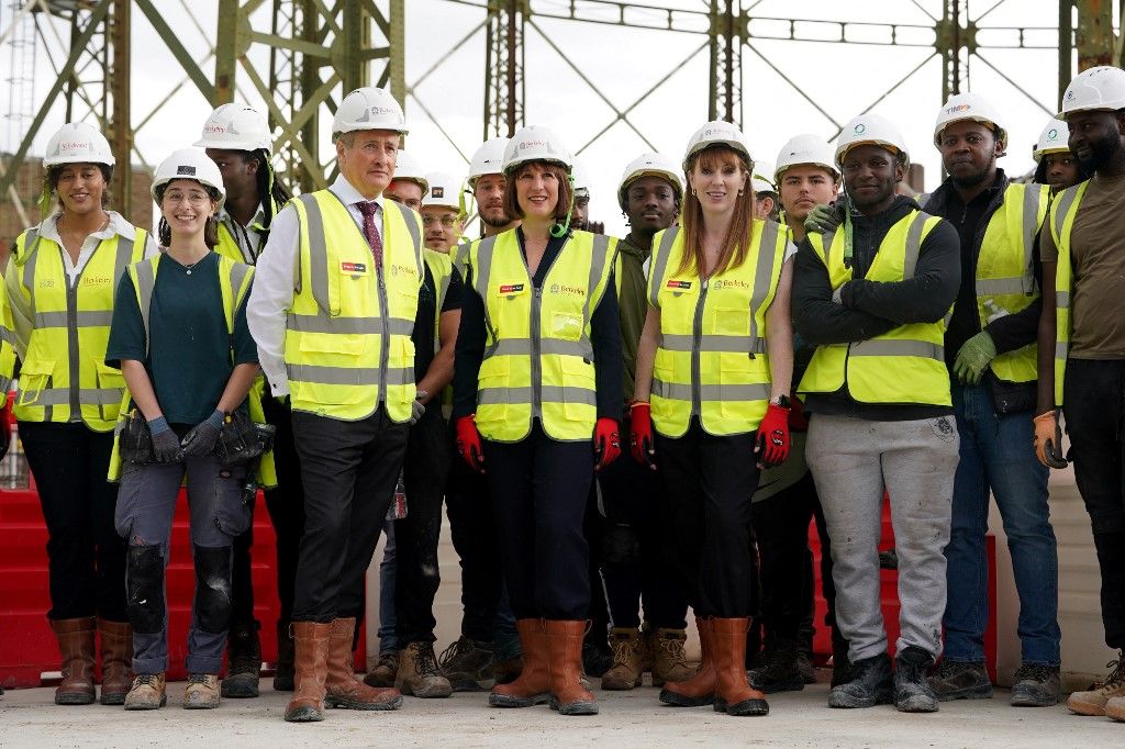 Britain's Chancellor of the Exchequer Rachel Reeves (C-L) and Britain's Deputy Prime Minister and Levelling Up, Housing and Communities Secretary Angela Rayner (C-R) visit the Oval Village project in London on July 8, 2024. Reeves vowed to immediately "fix the foundations" of Britain's economy, fuelled by onshore wind power and house building, after her Labour party won power. (Photo by Lucy NORTH / POOL / AFP)