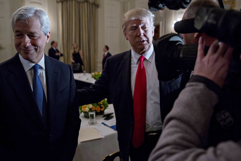 U.S. President Donald Trump stands next to Jamie Dimon, chief executive officer of JPMorgan Chase & Co., left, as he greets attendees during a Strategic and Policy Forum meeting in the State Dining Room of the White House in Washington, D.C., U.S., on Friday, Feb. 3, 2017. The gathering of the 18-member group, led by Blackstone Group LP CEO Steve Schwarzman, will give Americas first billionaire commander-in-chief a chance to reprise his Apprentice role on a grand scale. Photographer: Andrew Harrer/Bloomberg