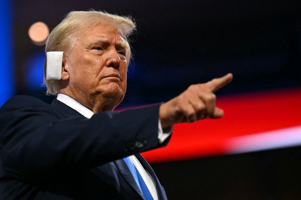 US former President and 2024 Republican presidential candidate Donald Trump points at the conclusion of the second day of the 2024 Republican National Convention at the Fiserv Forum in Milwaukee, Wisconsin, July 16, 2024. Days after he survived an assassination attempt Donald Trump won formal nomination as the Republican presidential candidate and picked right-wing loyalist J.D. Vance for running mate, kicking off a triumphalist party convention in the wake of last weekend's failed assassination attempt. (Photo by ANGELA WEISS / AFP)