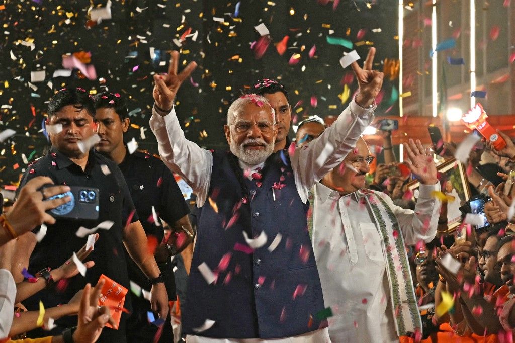 India’s Prime Minister Narendra Modi flashes victory sign as he arrives at the Bharatiya Janata Party (BJP) headquarters to celebrate the party’s win in country's general election, in New Delhi on June 4, 2024. Modi claimed election victory for his party and its allies on June 4, but the opposition said they had "punished" the ruling party to confound predictions and reduce their parliamentary majority. (Photo by Arun SANKAR / AFP)