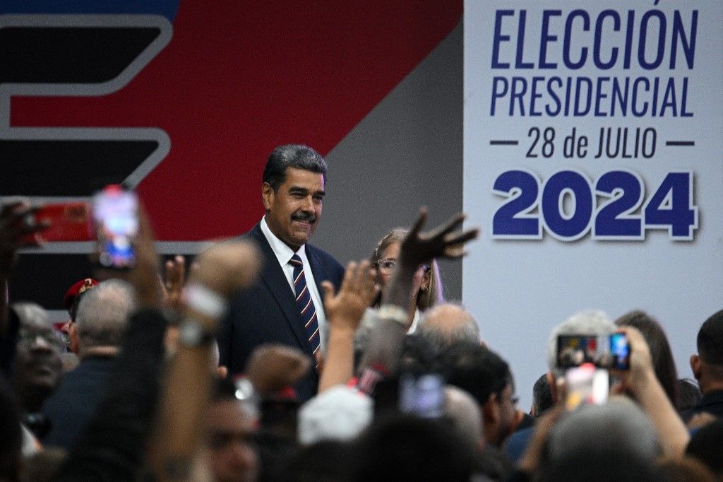 Venezuelan President Nicolas Maduro (L), accompanied by his wife Cilia Flores, attends his proclamation at the National Electoral Council (CNE) headquarters in Caracas on July 29, 2024, a day after the Venezuelan presidential election. President Nicolas Maduro was declared the winner of Venezuela's presidential election but the opposition and key regional neighbours immediately rejected the official results. (Photo by Federico PARRA / AFP)