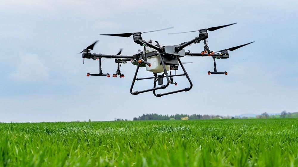 Drone,Flying,Over,A,Green,Grass,Field,With,Cloudy,Sky