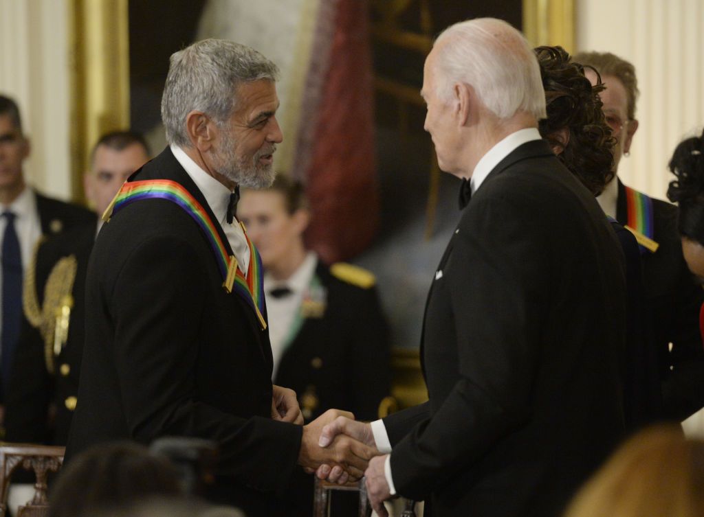 US President Joe Biden, right, greets actor George Clooney during the Kennedy Center honoree reception in the East Room of the White House in Washington, DC, US, on Sunday, Dec, 4, 2022. The John F. Kennedy Center for the Performing Arts 45th honorees for lifetime artistic achievements include actor and filmmaker George Clooney, contemporary Christian singer-songwriter Amy Grant, singer Gladys Knight, composer and conductor Tania Leon and Irish rock band U2. Photographer: Bonnie Cash/UPI/Bloomberg