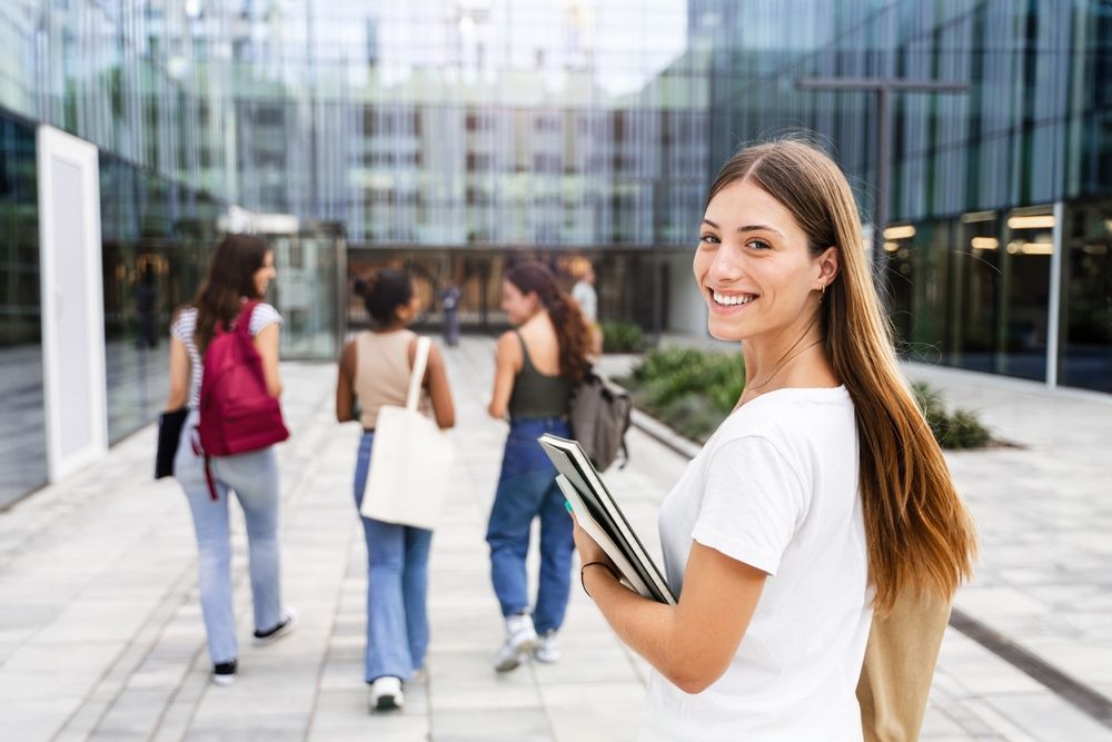 Group,Of,College,Girl,Friends,Walking,Towards,Of,University,Building.