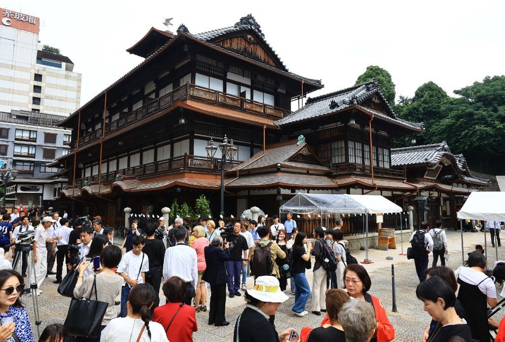 Local people and the Officials of Dogo Onsen Honkan main building celebrate the following day's reopening of full business operations in Matsuyama City, Ehime Prefecture, Japan on July 10th, 2024. The National Important Property had been repaired for five and a half years. ( The Yomiuri Shimbun ) (Photo by Makoto Kondo / Yomiuri / The Yomiuri Shimbun via AFP)