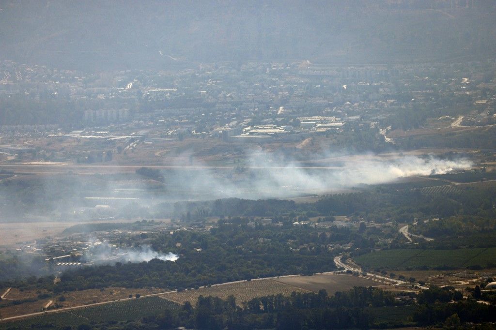 Smoke billows after a hit from a rocket fired from southern Lebanon over the Upper Galilee region in northern Israel on July 30, 2024, amid ongoing cross-border clashes between Israeli troops and Hezbollah fighters. Israeli medics on Tuesday said one civilian, a 30-year-old man, was killed following a rocket attack on the northern kibbutz of HaGoshrim. The Israeli army meanwhile reported its forces were "striking the sources of fire" after the projectiles were fired from Lebanon. (Photo by Jalaa MAREY / AFP)