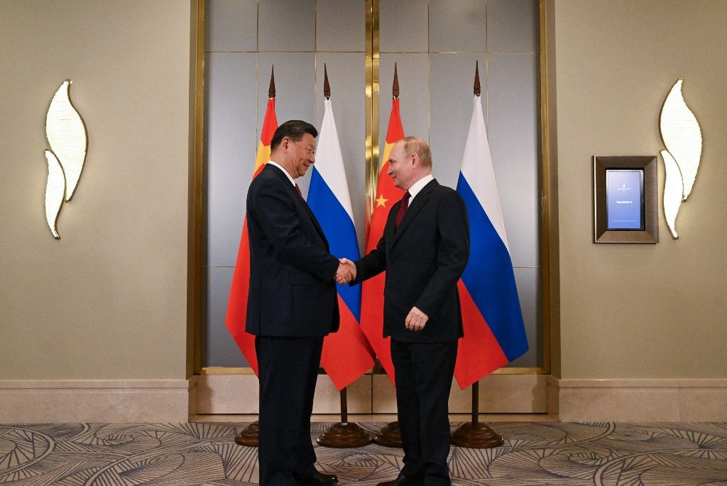 In this pool photograph distributed by the Russian state agency Sputnik, Russia's President Vladimir Putin meets with China's President Xi Jinping on the sidelines of the Shanghai Cooperation Organisation (SCO) member states leaders' summit in Astana on July 3, 2024. (Photo by Sergei GUNEYEV / POOL / AFP)