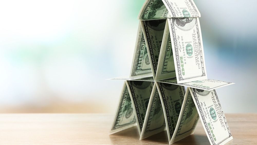 Money,Pyramid,On,Wooden,Table,,Close,Up