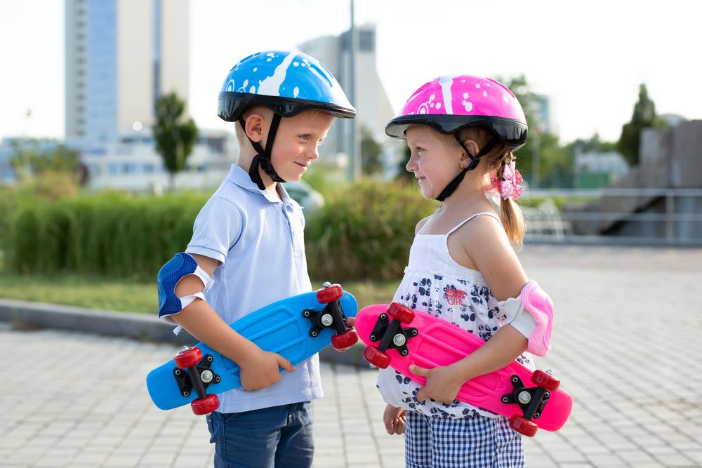 Little,Brother,And,Sister,Go,Skateboarding,In,The,Park,In