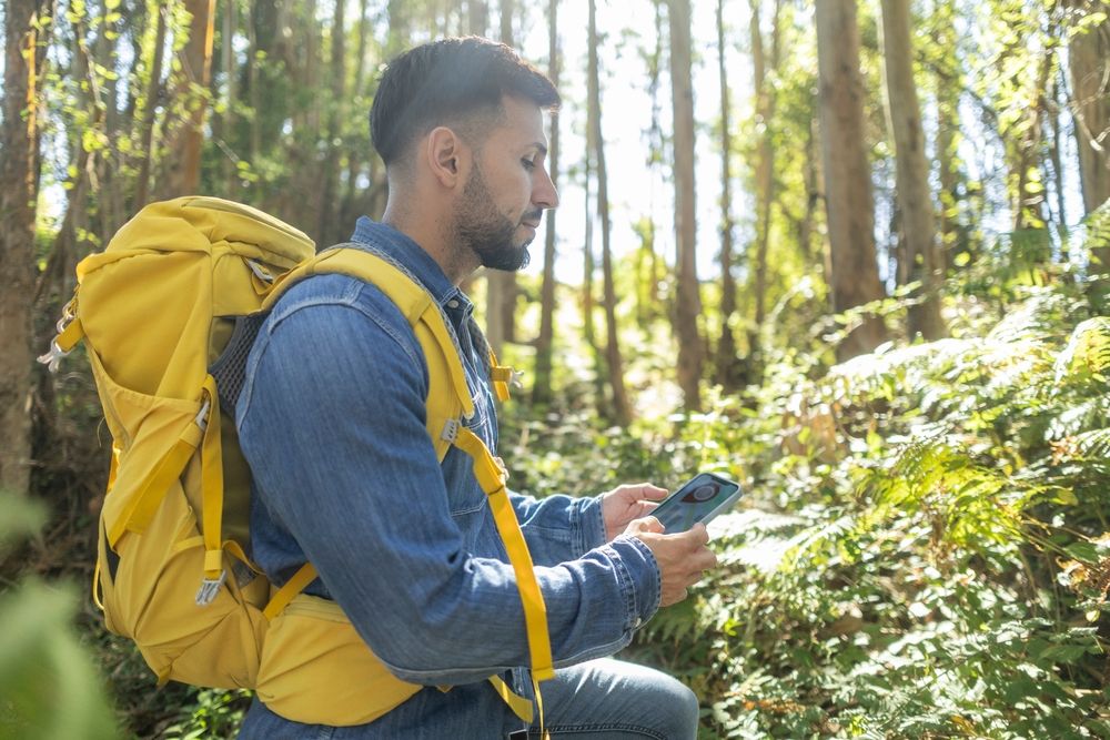 Backpacker,Hiker,Man,Lost,In,The,Forest,Looking,At,His