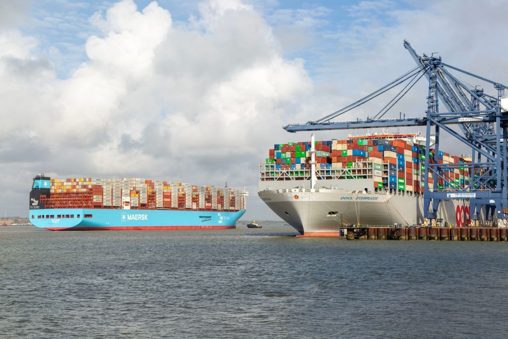 Ane Maersk container ship arriving at Port of Felixstowe, Suffolk, England, UK OOCL Zeebrugge at quayside